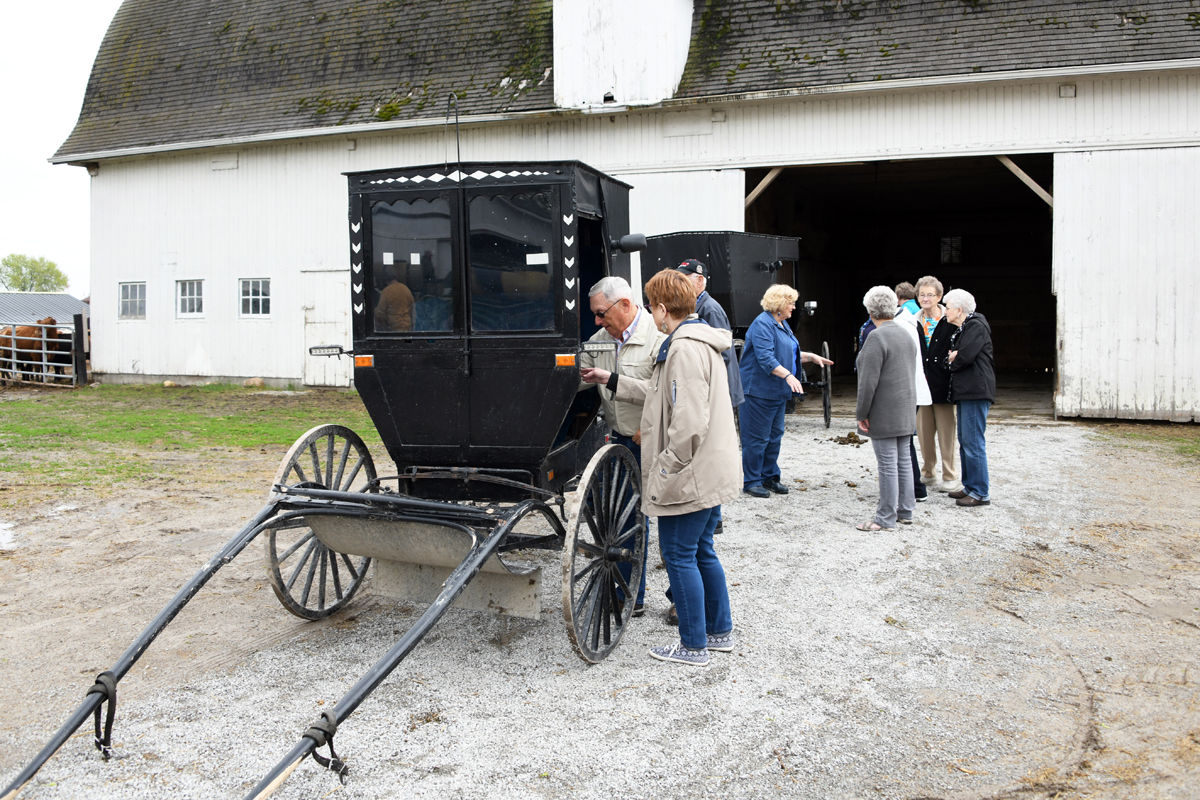 129 Don and Donna Regier examine an Amish buggy.JPG